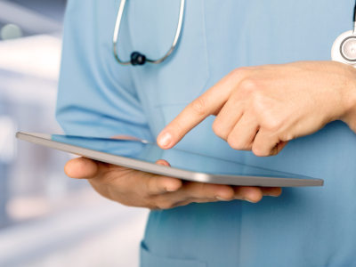 Medical professional using a medical resource on her ipad