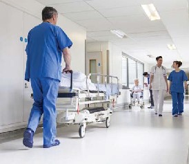 doctor transferring patient down hallway